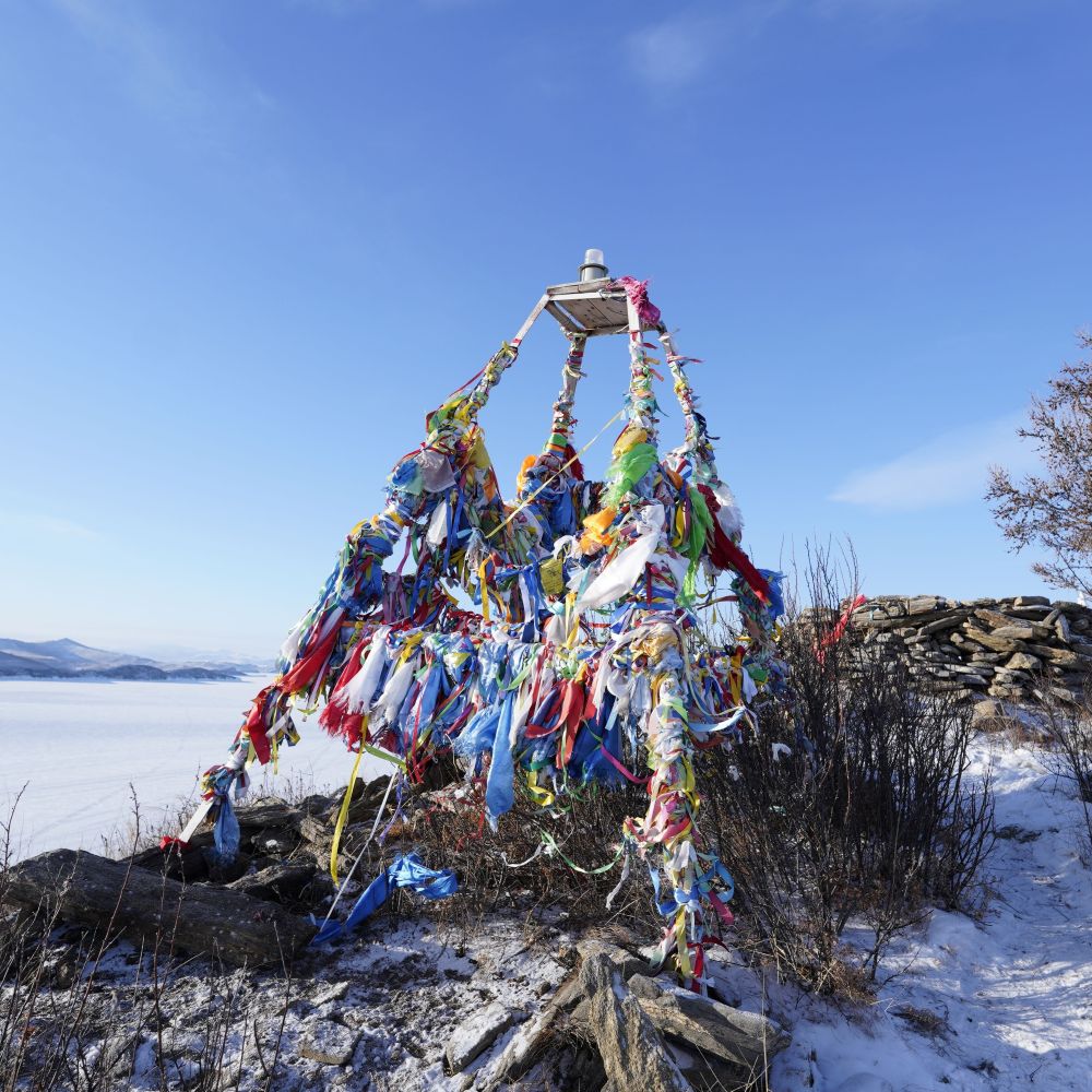 Buddhist prayer flags on winter Lake Baikal
